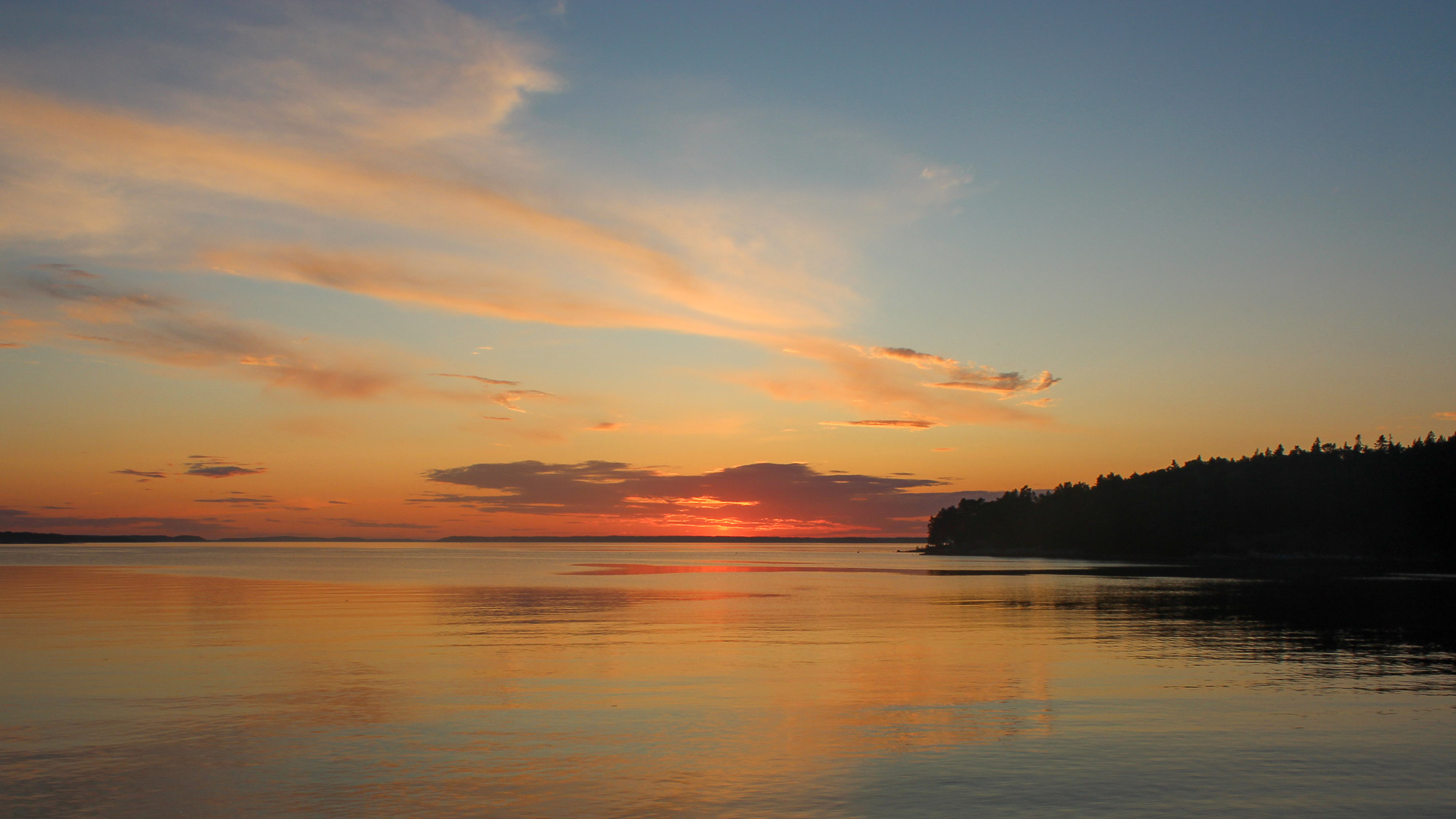 Just after the sun had set in the Stockholm archipelago. The calm mirror like water reflecting the red, orange and pink colours of the sky. The most southern part of the island Utö is featured to the right of the image.